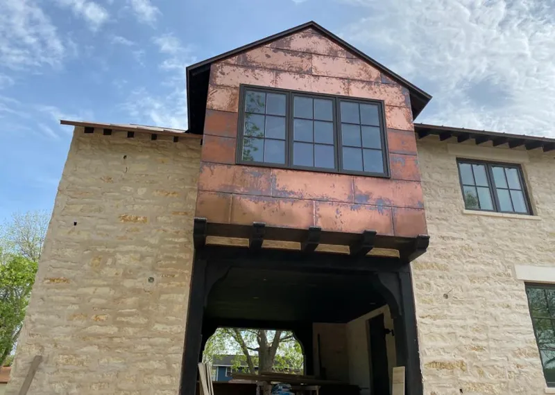 Copper metal panel facade on a stone building for Roof Repair in Claremont