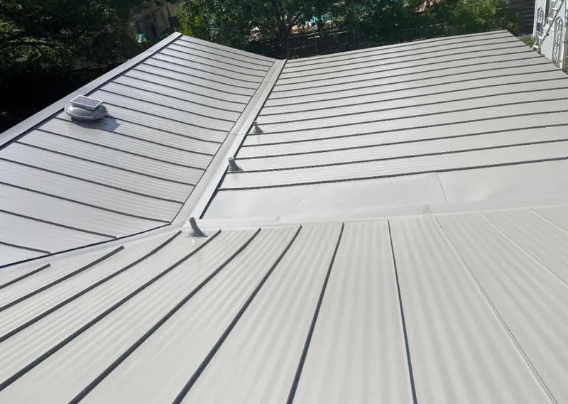 Solar attic fan installed on a metal roof for Roof Ventilation in Claremont